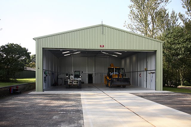 Interior view of steel aircraft hangar showing spacious storage area and wide hangar entrance.