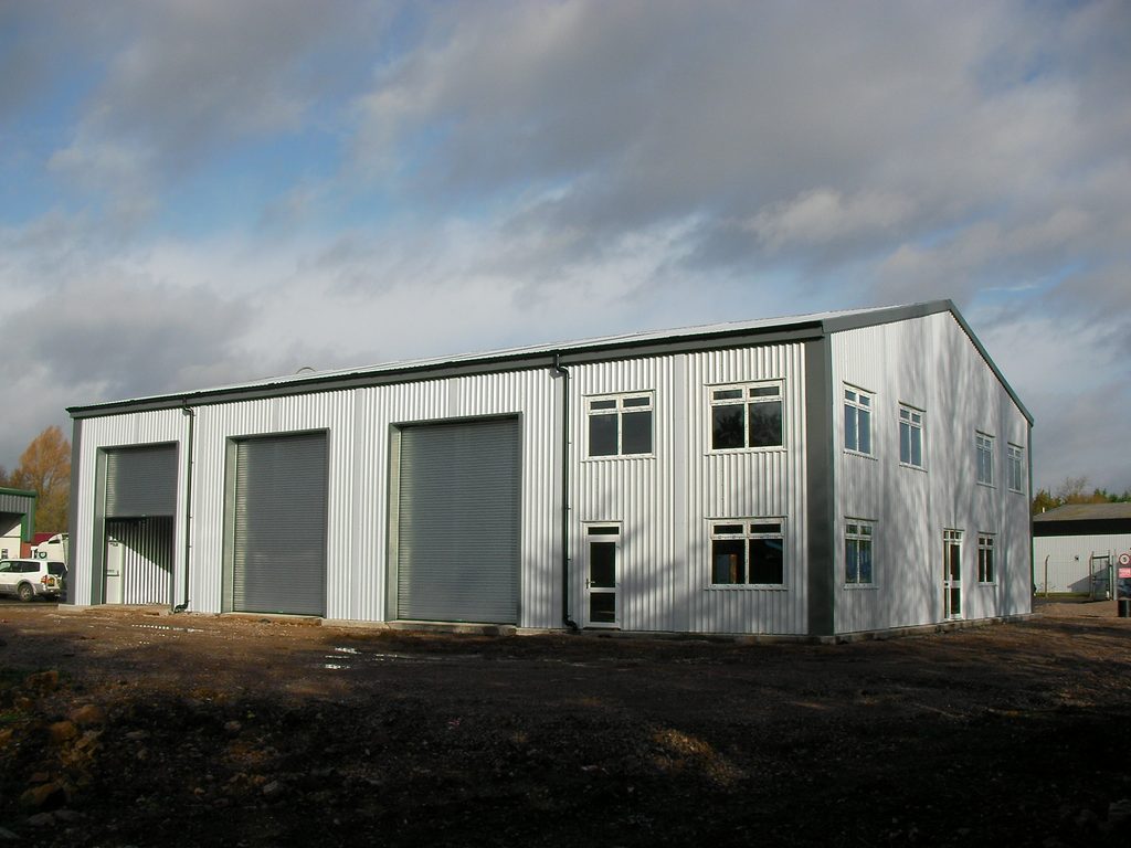 Two storey prefabricated steel office building with windows and ground-floor access doors.