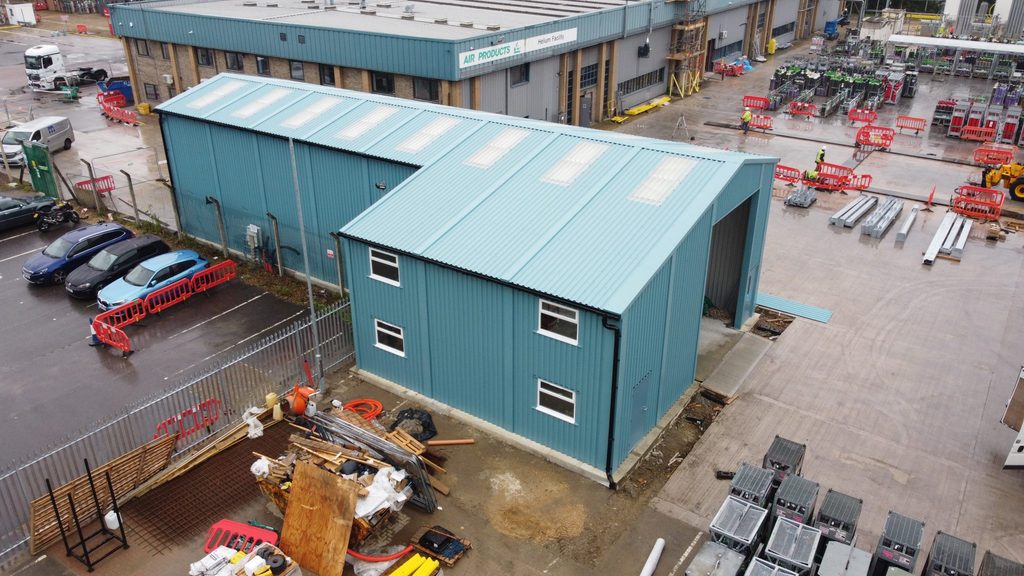Prefabricated steel industrial building for Air Products, featuring blue cladding, two-storey office space and adjoining workshop space.
