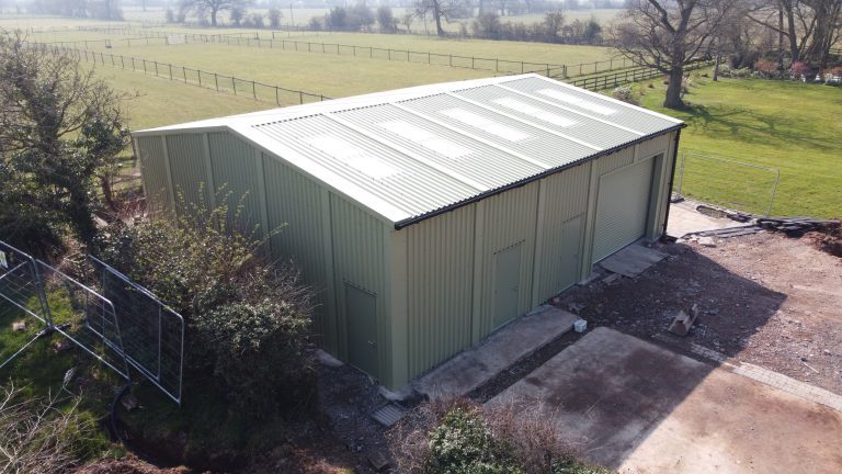 Prefabricated steel storage building with roller shutter door in side and multiple personnel doors for D L Farmer, Priory Farm, Staffordshire.