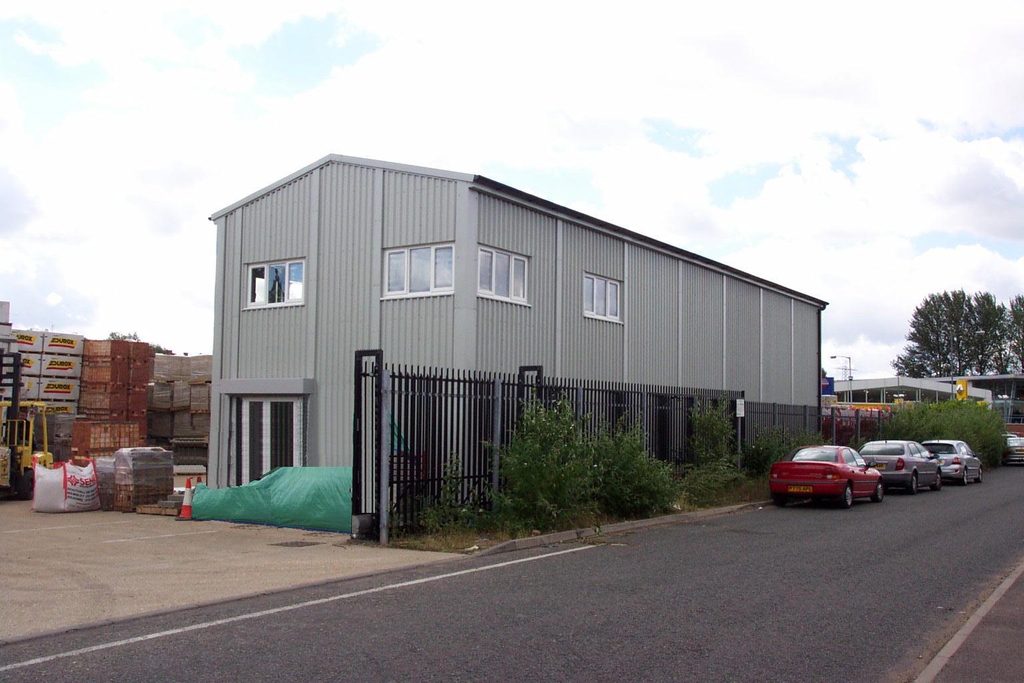 Two-storey steel office and stores building with upper-floor windows and ground-floor accommodation.