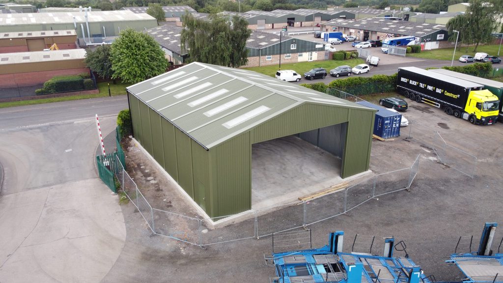Compact green prefabricated steel vehicle storage building manufactured, by Saredon Steel Buildings and installed in Aldridge for Langley