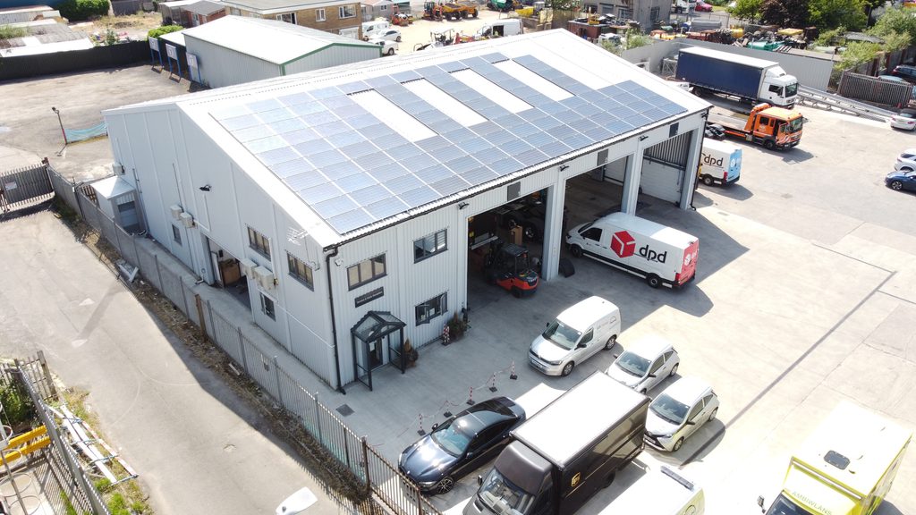 Aerial view of W G Davies steel vehicle maintenance depot, featuring solar panels, multiple workshop bays and vehicle access doors.