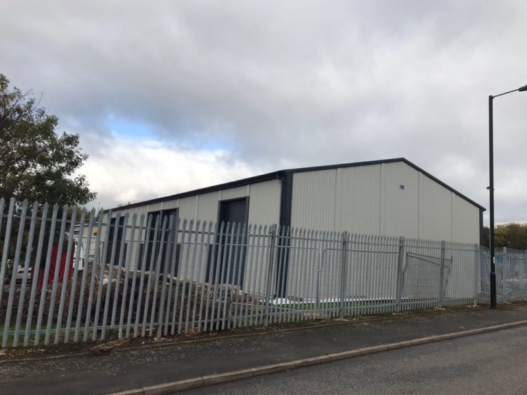 Large Steel Commercial Unit with three access roller shutters along the side elevation for Walkfern in Aldridge.