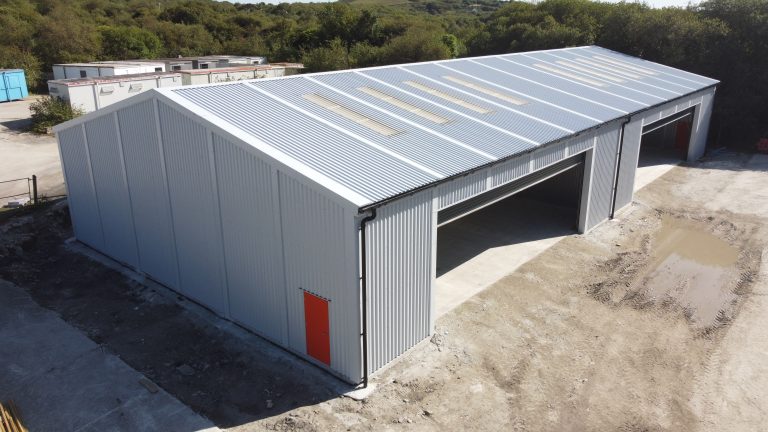 Aerial view of prefabricated steel industrial building for Wernick in St Austell, featuring two large vehicle access openings, rooflights and a personnel door.